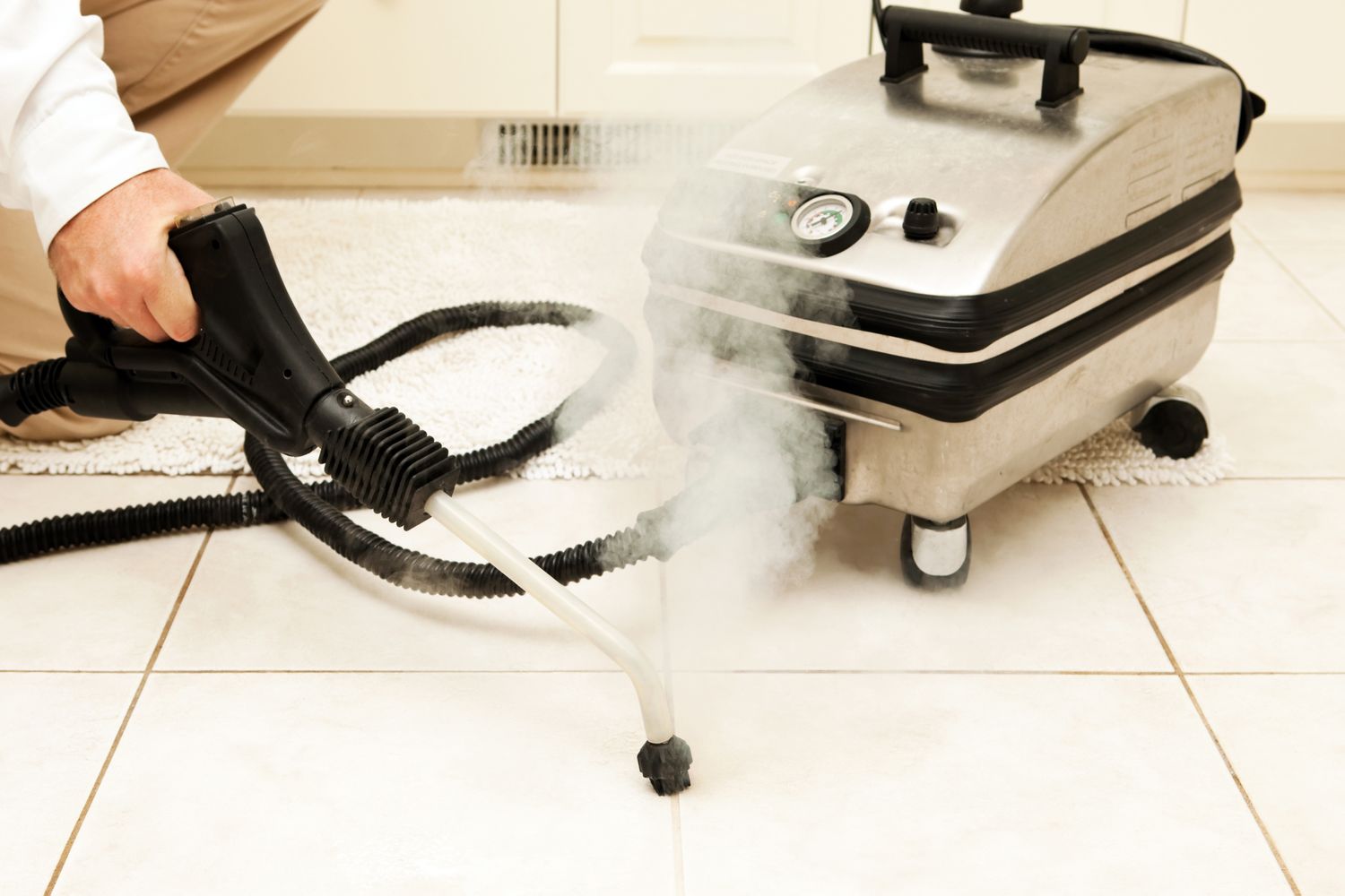 Steam cleaner being used on tile and grout lines